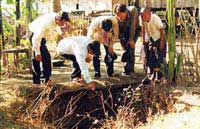 CRDT team examining open pit well